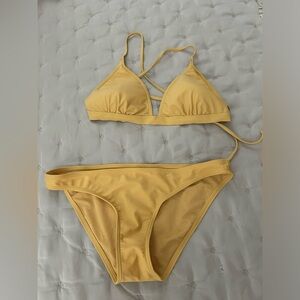 Rip curl gold bikini. Top in large. Bottom in large. Never worn. No tags.